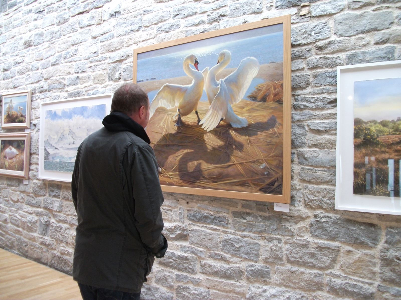 Visitor looking at painting