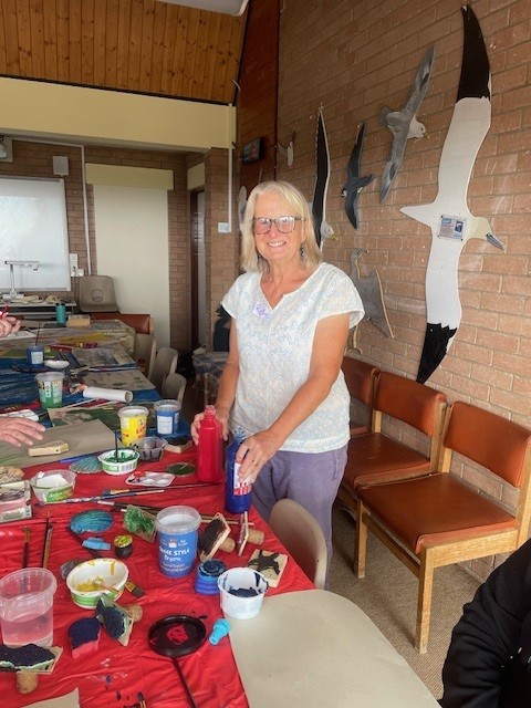 Volunteer next to craft table 