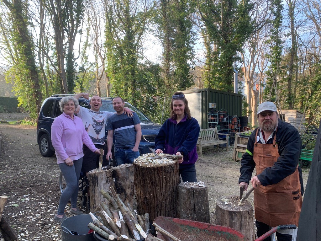 Volunteers woodworking in the shed garden