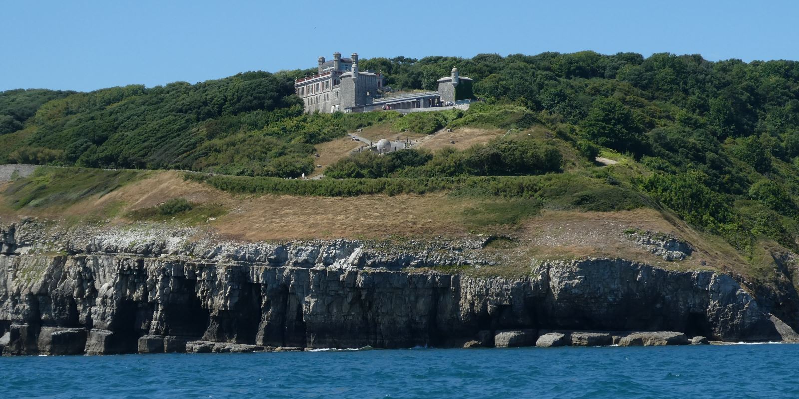 A view of Durlston Castle from the sea