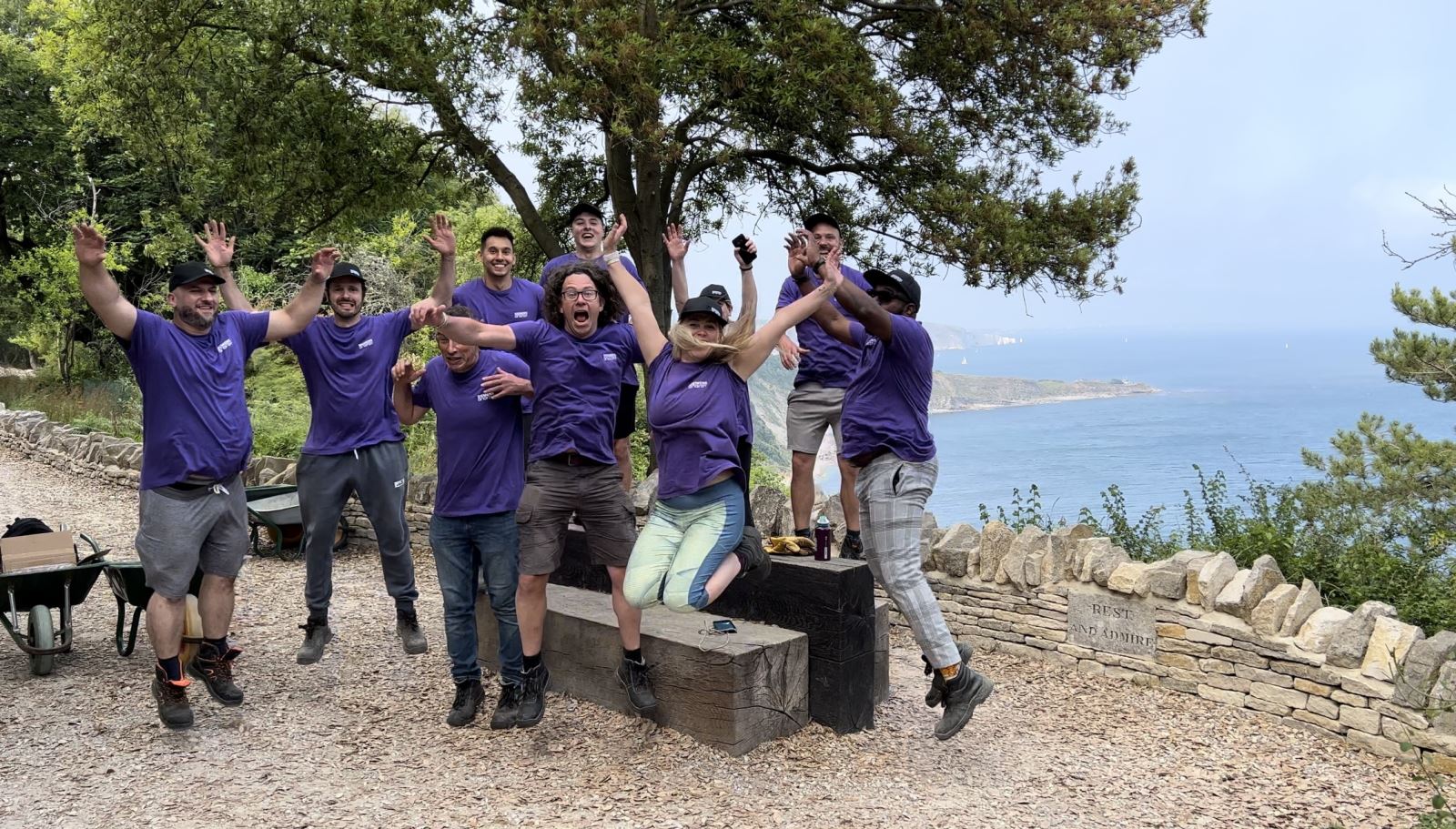 Volunteers walking along path near the sea